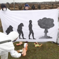 Peace activists protest against nuclear weapons in front of a military base near Peer, Belgium. | REUTERS