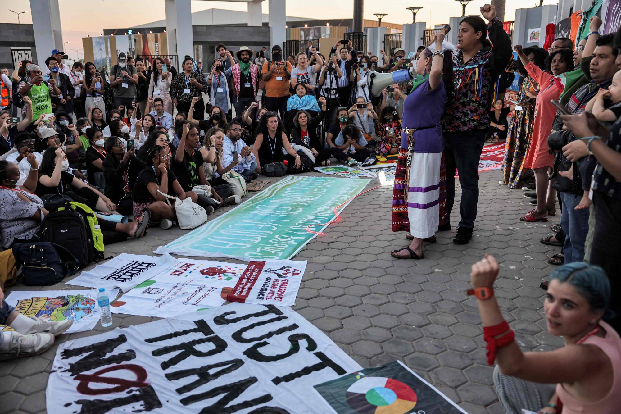 Climate activists chant slogans during the COP27 climate conference in Egypt's Red Sea resort city of Sharm el-Sheikh on Friday. | AFP-Jiji