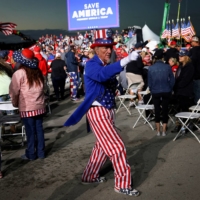 A person dressed as \"Uncle Sam\" attends a pre-election rally held by former U.S. President Donald Trump in support of Republican candidates in Latrobe, Pennsylvania, on Nov. 5. | REUTERS