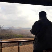 North Korean leader Kim Jong Un and his daughter watch the launch of an intercontinental ballistic missile in this undated photo released on Saturday. | KCNA / VIA REUTERS