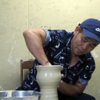 Ceramicist Kim Kyungduk demonstrates his throwing technique at his studio in Nanto, Toyama Prefecture. | MIO YAMADA
