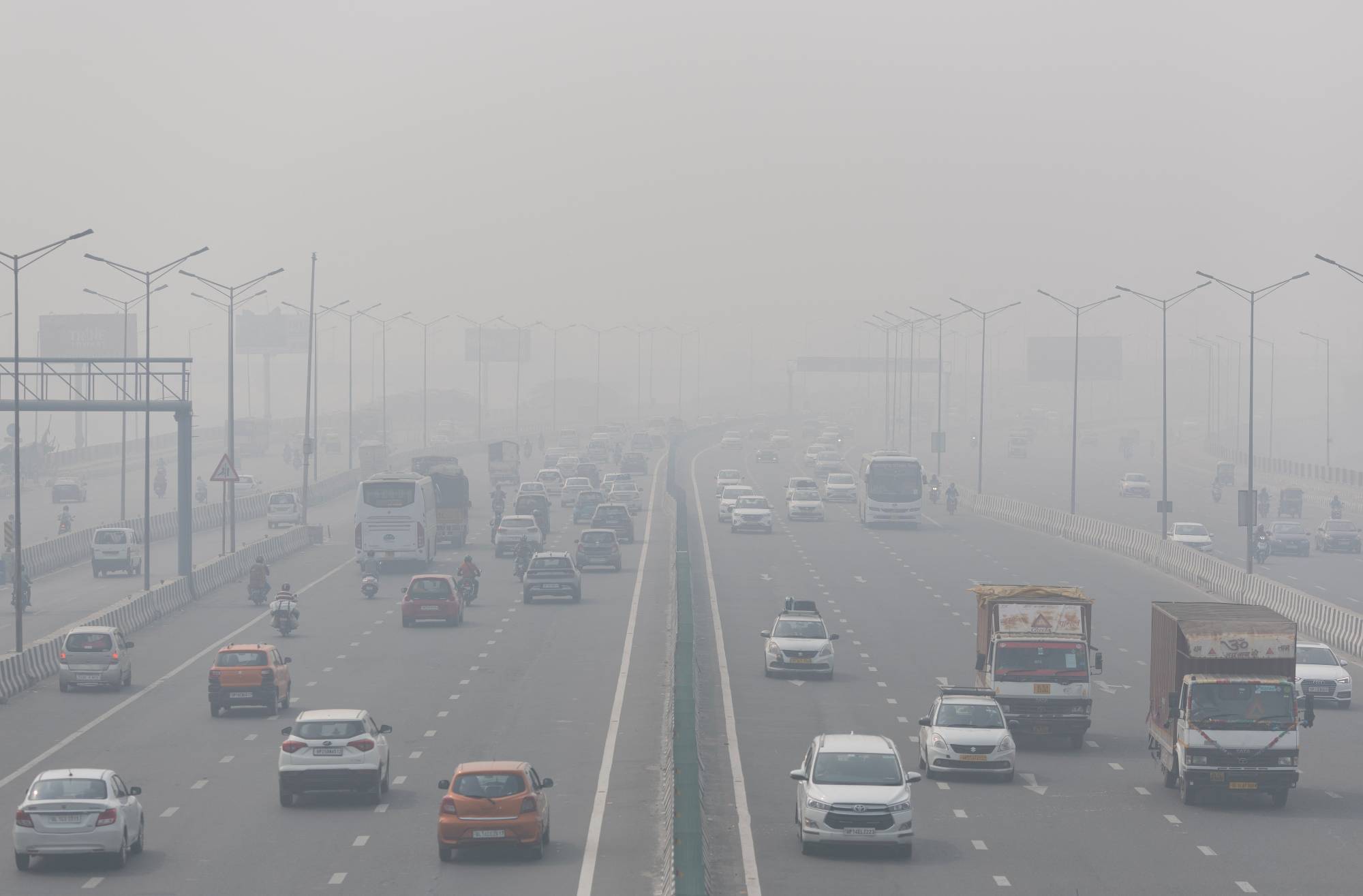 Traffic moves along a highway shrouded in heavy smog in New Delhi. | REUTERS 