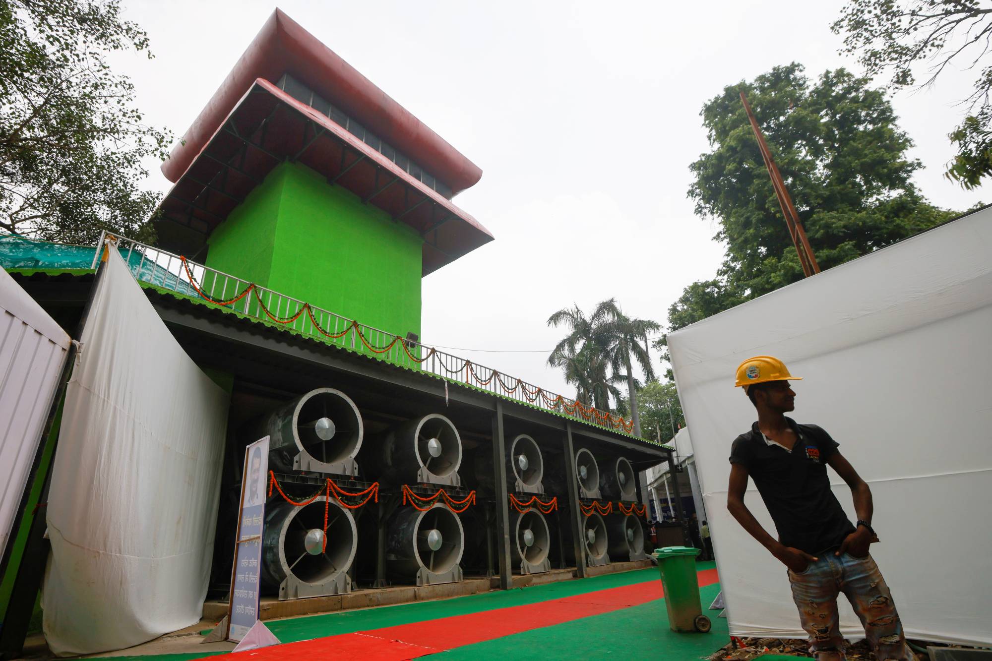 A worker stands next to a newly installed 