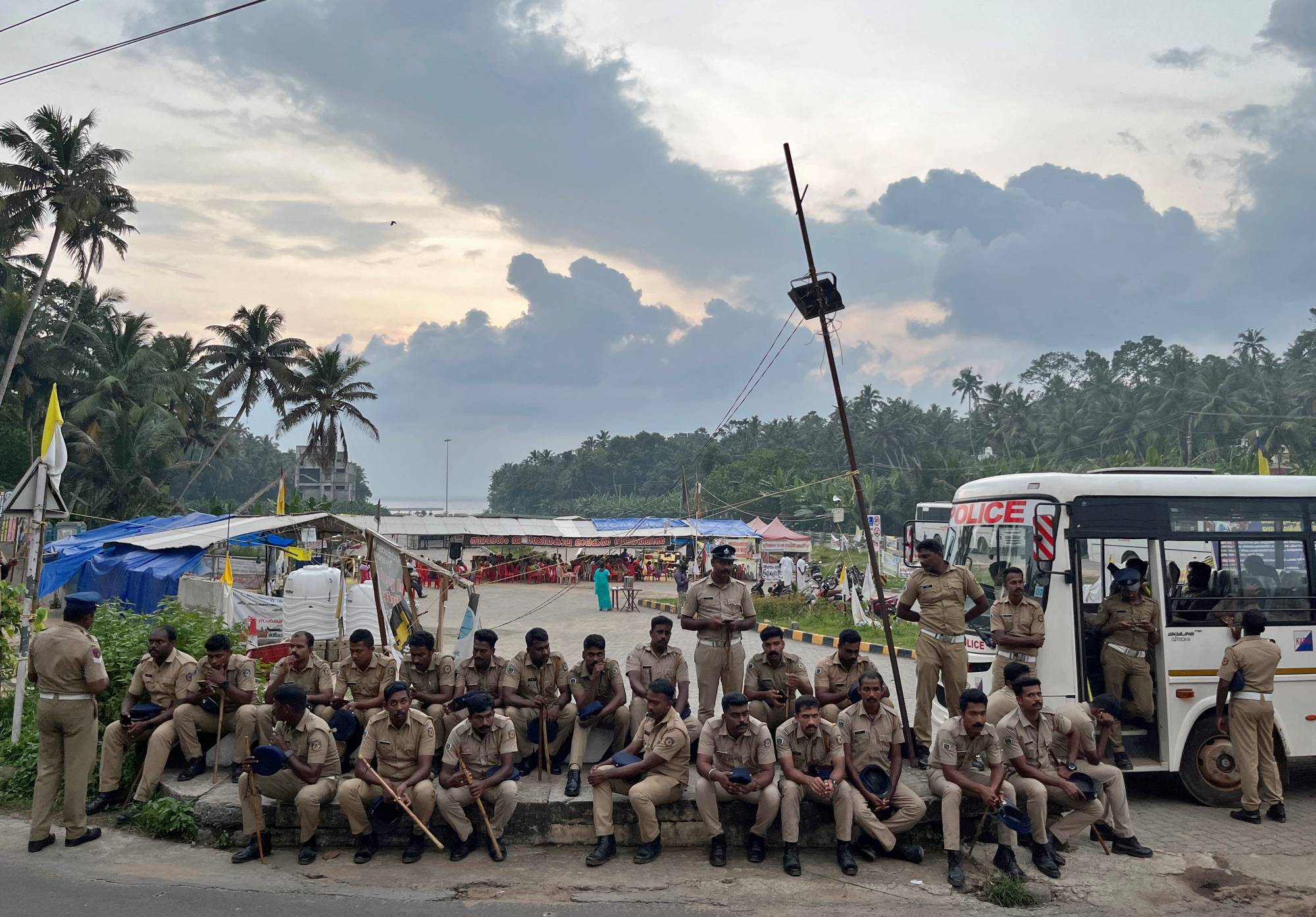 Police officers are deployed as fishermen protest near the entrance of the proposed Vizhinjam Port. | REUTERS