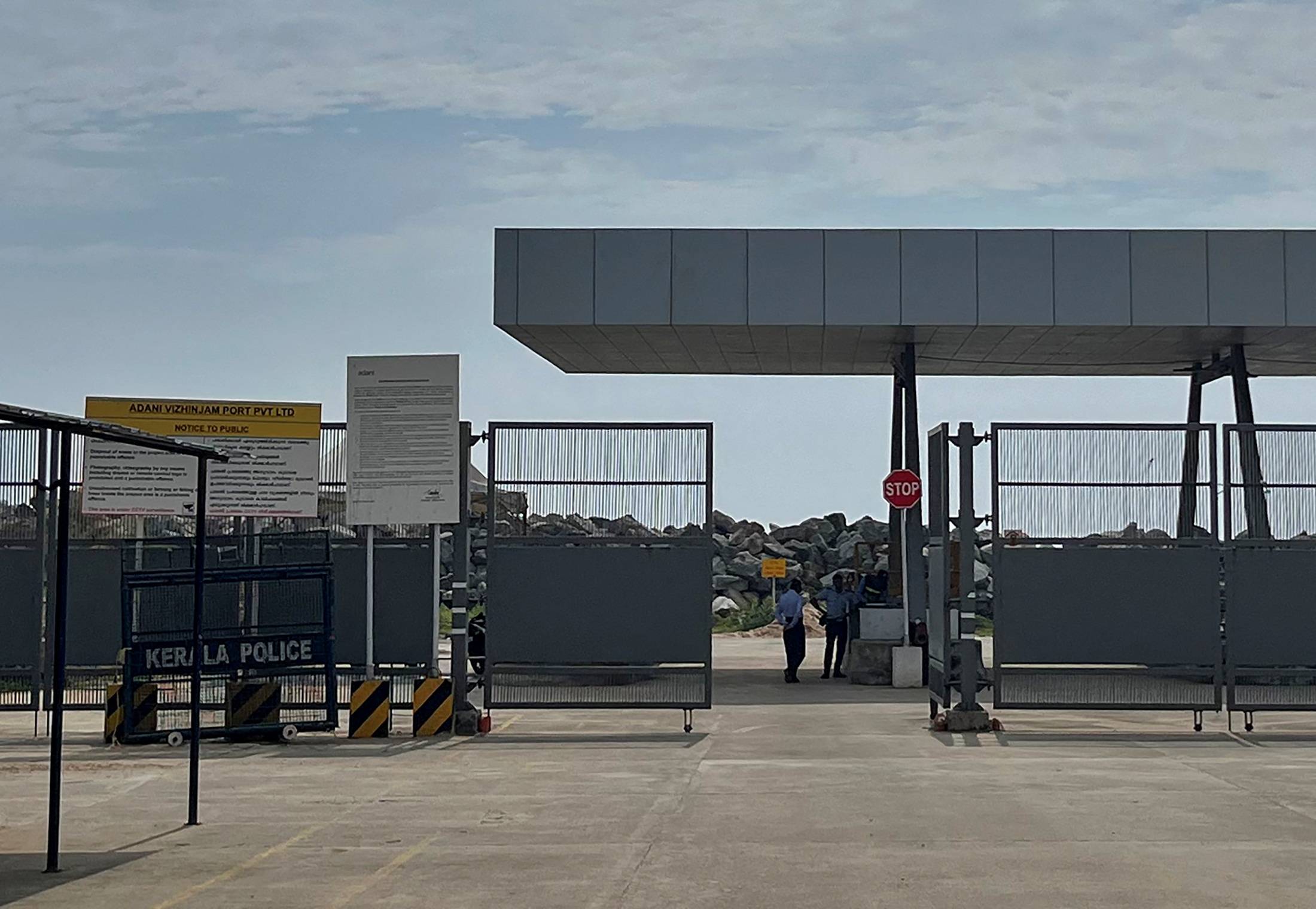 Private security guards stand near an entrance of the proposed Vizhinjam Port. | REUTERS