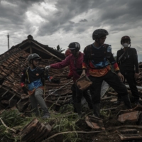Indonesian search and rescue teams look for victims in Cugenang village, following a landslide triggered by an earthquake, in Cianjur, West Java, Indonesia on Wednesday.  | ULET IFANSASTI / THE NEW YORK TIMES