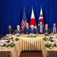 U.S. President Joe Biden (center) meets with South Korean President Yoon Suk-yeol (left) and  Prime Minister Fumio Kishida on the sidelines of the Association of Southeast Asian Nations summit in Phnom Penh on Nov. 13. | DOUG MILLS / THE NEW YORK TIMES