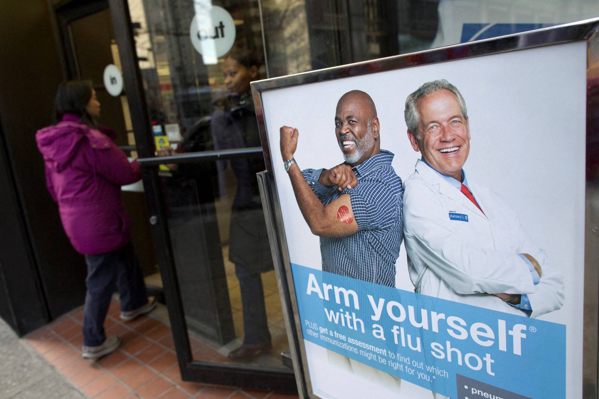 A sign outside a pharmacy in New York promotes flu shots. A universal vaccine would replace the guess work involved in developing annual shots months ahead of flu season each year. | REUTERS 