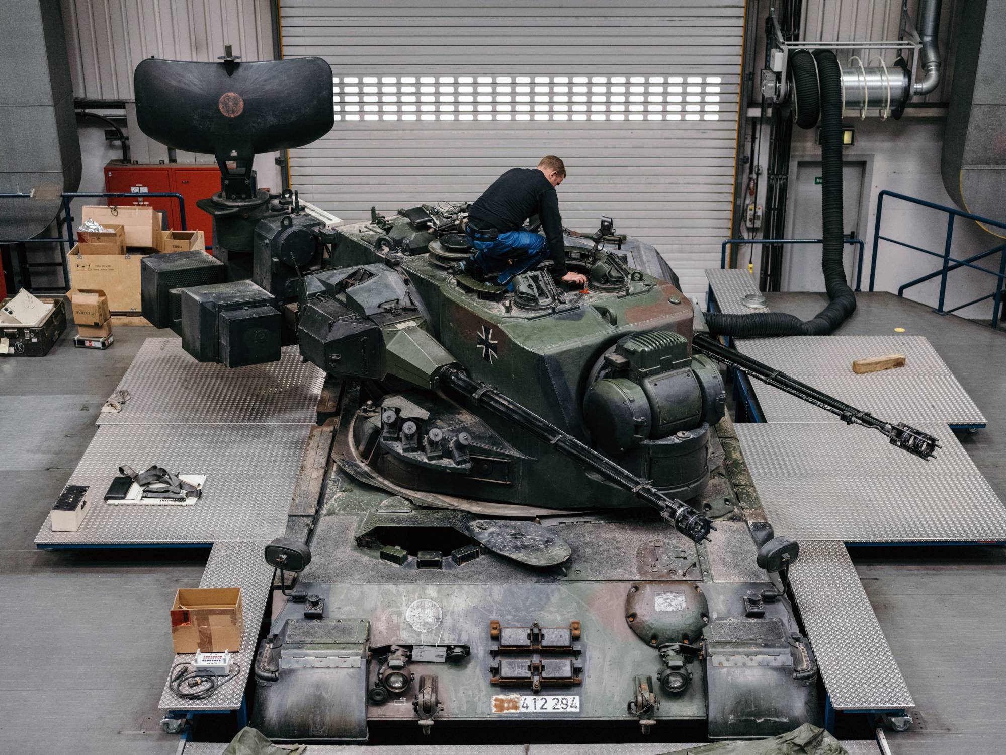 A mechanic works on a Gepard mobile antiaircraft system at the Krauss-Maffei Wegmann factory in Munich in April 2022. In Ukraine, the kind of European war thought inconceivable — heavy use of artillery and tanks — is chewing up modest stockpiles of artillery, ammunition and air defenses. | FELIX SCHMITT / THE NEW YORK TIMES