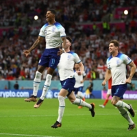 England\'s Marcus Rashford celebrates after scoring his first of two goals against Wales in the 2022 FIFA World Cup Group B match in Al Rayyan, Qatar, on Tuesday. | REUTERS