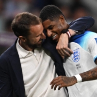 England coach Gareth Southgate congratulates Marcus Rashford as he is substituted after scoring two goals against Wales during their 2022 FIFA World Cup Group B match in Al Rayyan, Qatar, on Tuesday. | AFP-JIJI
