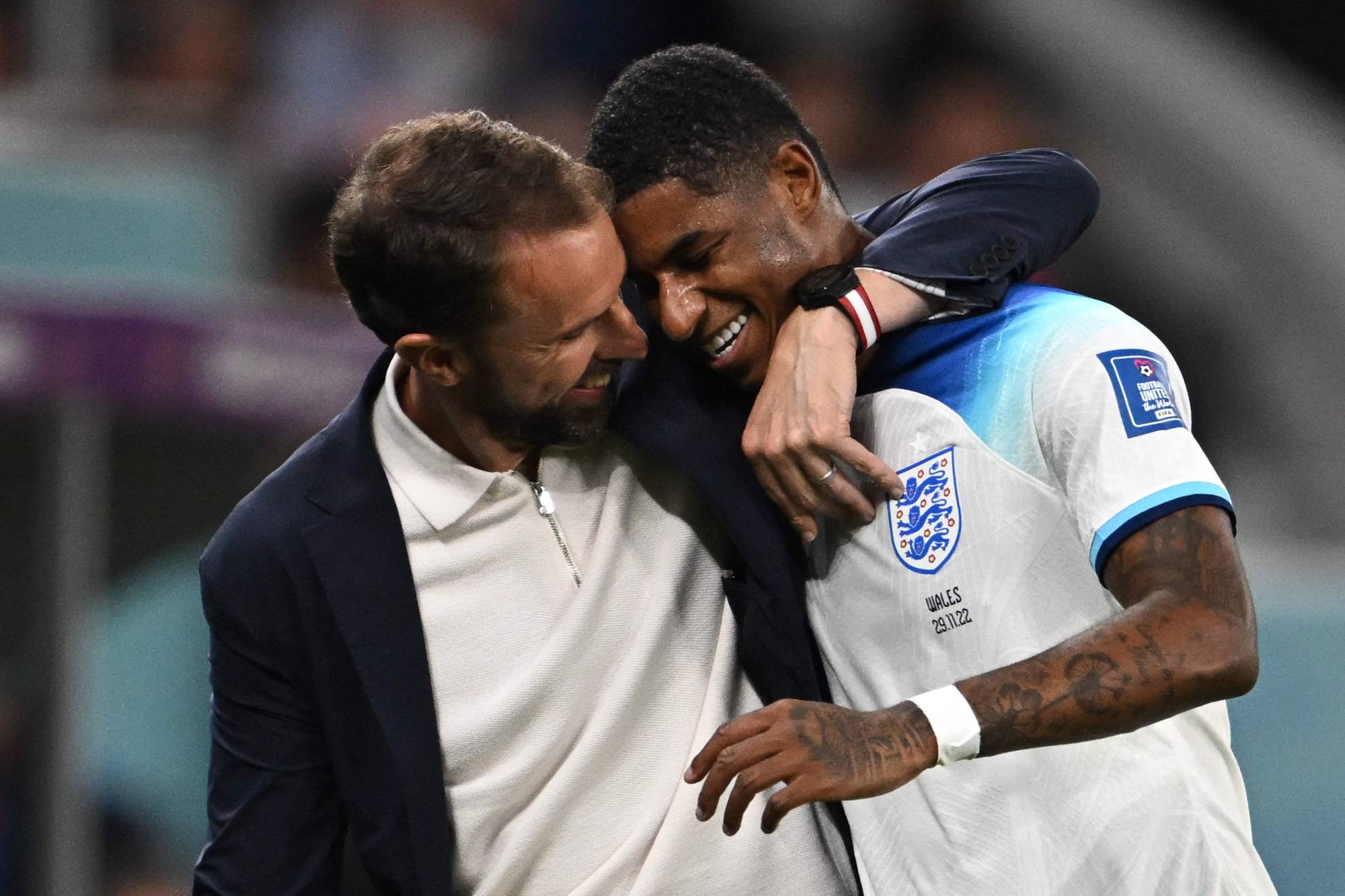 England coach Gareth Southgate congratulates Marcus Rashford as he is substituted after scoring two goals against Wales during their 2022 FIFA World Cup Group B match in Al Rayyan, Qatar, on Tuesday. | AFP-JIJI