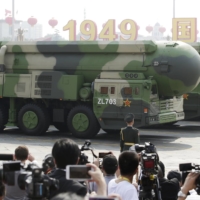 Chinese military vehicles carrying DF-41 intercontinental ballistic missiles travel past Beijing\'s Tiananmen Square during a military parade marking the 70th founding anniversary of the People\'s Republic of China on Oct. 1, 2019. | REUTERS