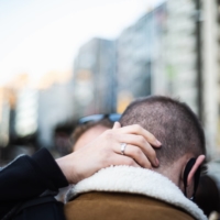 Two friends share a hug in Tokyo. Departures can be tough, especially if you are planning to leave the country altogether.  | JOHAN BROOKS
