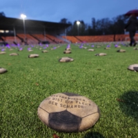 Flat soccer balls filled with sand set by the artist Volker-Johannes Trieb are seen during the opening game of the 2022 FIFA World Cup to commemorate what activists say are deaths of thousands of workers who lost their lives to build the stadiums for the tournament in Qatar, in Herne, Germany, on Nov. 20. | REUTERS