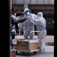 Pandemic prevention workers in Beijing on Friday | REUTERS
