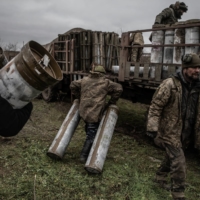 Members of a Ukrainian artillery team work during an operation to fire upon a Russian ammunition depot across the Dnieper River, in Ukraine’s southern Kherson region on Thursday. | FINBARR O’REILLY / THE NEW YORK TIMES