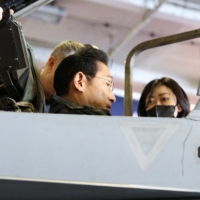 Prime Minister Fumio Kishida sits in a F/A-18 Hornet fighter jet as he boards the USS Ronald Reagan aircraft carrier in Sagami Bay, off Yokosuka, Kanagawa Prefecture, on Nov. 6. | REUTERS
