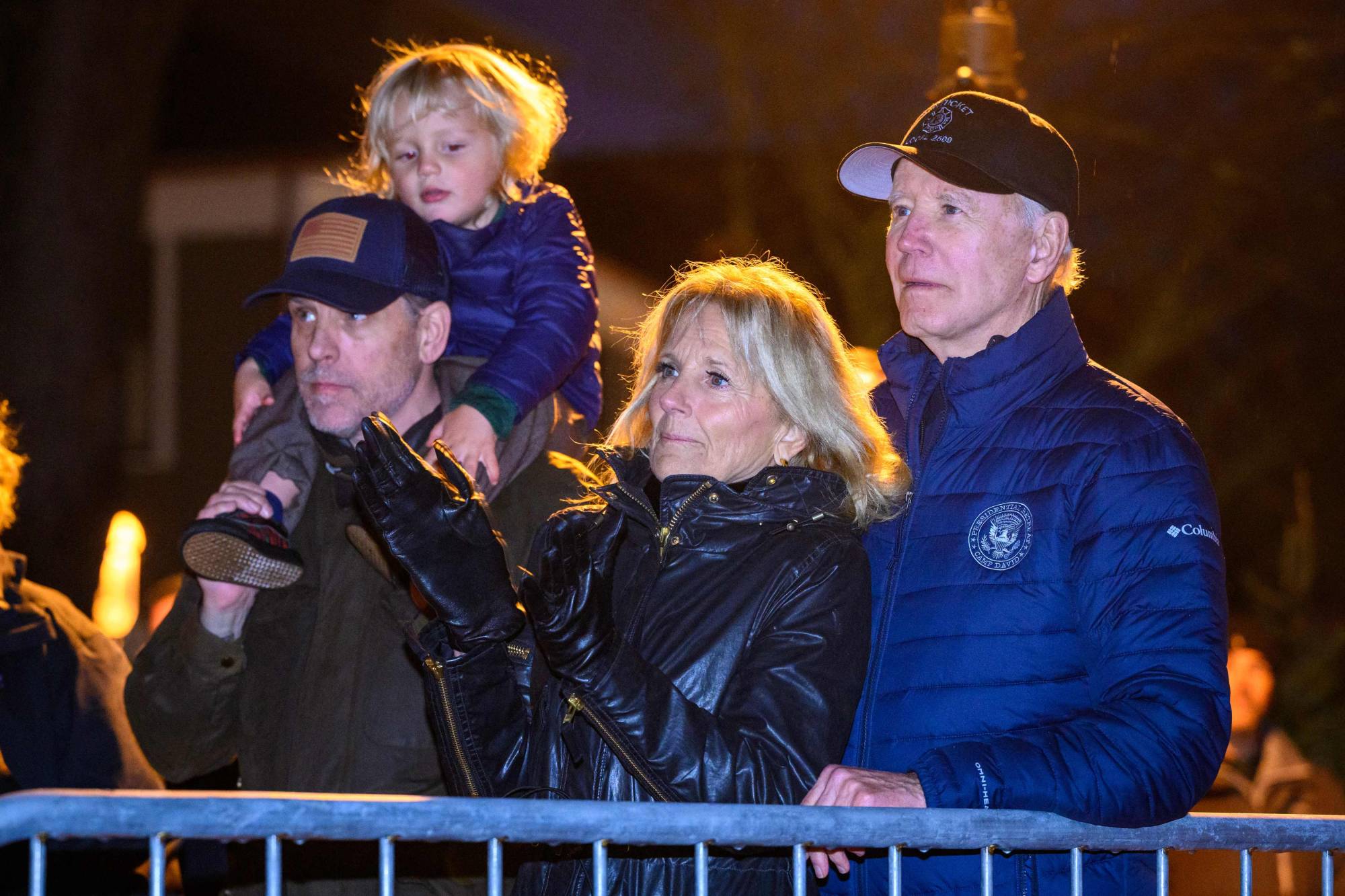 U.S. President Joe Biden and first lady Jill Biden watch a Christmas tree-lighting ceremony with the president's son Hunter Biden and his grandson Beau Jr. during their family's Thanksgiving holiday in Nantucket, Massachusetts, on Nov. 25. | AFP-JIJI