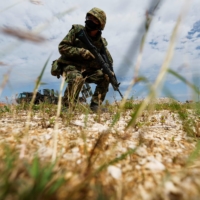 A Ground Self-Defense Force member conducts a military drill next to an anti-ship missiles unit at the GSDF camp on Miyako Island in Okinawa Prefecture on April 21. | REUTERS