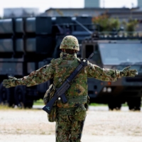 A Ground Self-Defense Force member conducts a military drill with an anti-ship missile unit, at the GSDF camp on Miyako Island in Okinawa Prefecture in April. | REUTERS