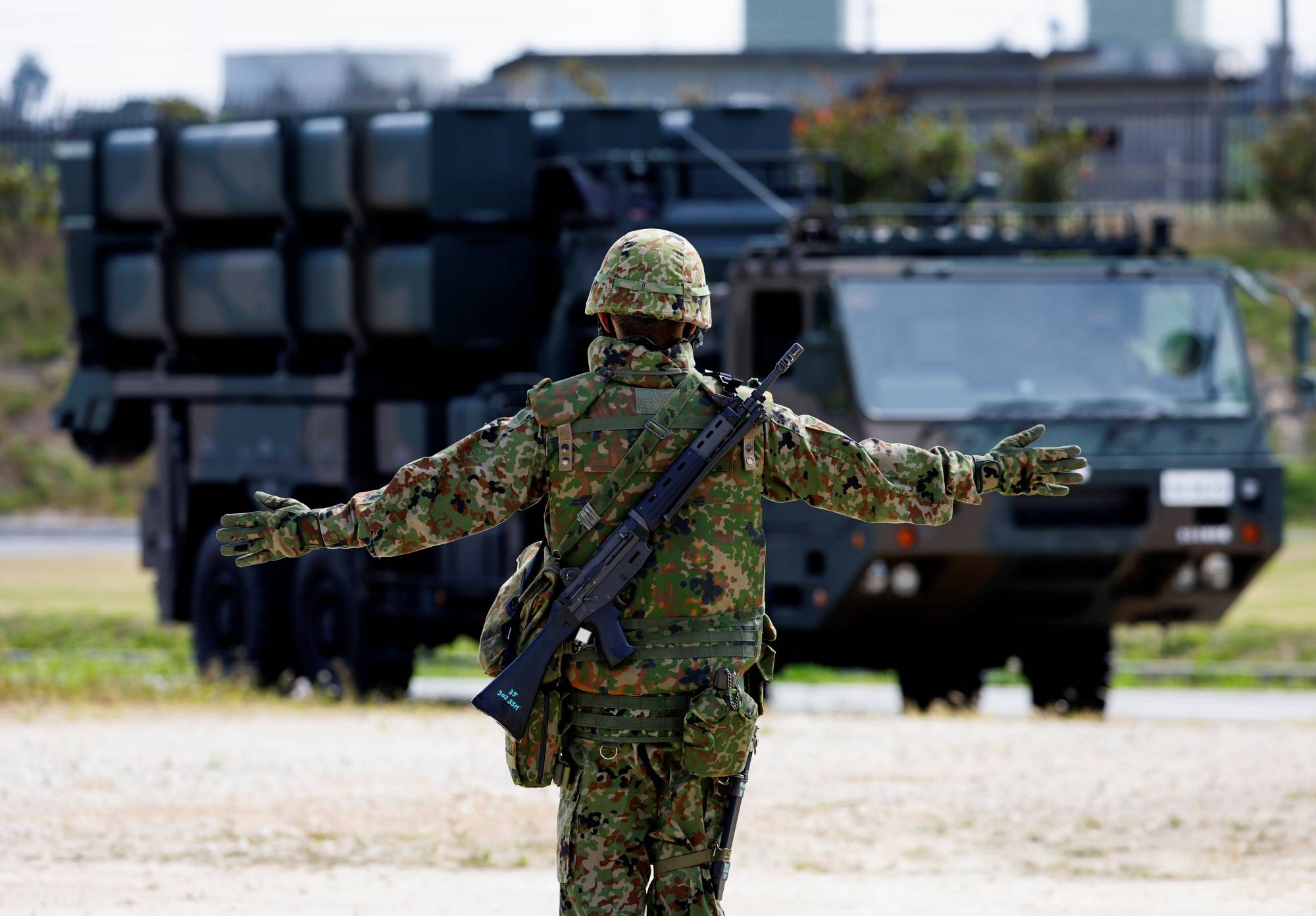 A Ground Self-Defense Force member conducts a military drill with an anti-ship missile unit, at the GSDF camp on Miyako Island in Okinawa Prefecture in April. | REUTERS