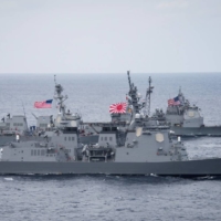 A Maritime Self-Defense Force destroyer and two U.S. Navy guided-missile destroyers transit the Philippine Sea in April 2017.  | U.S. NAVY / VIA REUTERS 