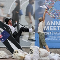 Activists call for financial action on debt collection and other issues outside the IMF-World Bank headquarters in Washington in October 2021. | REUTERS