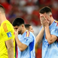 Spanish players look dejected after losing their round of 16 match against Morocco in Al Rayyan, Qatar, on Tuesday. | REUTERS