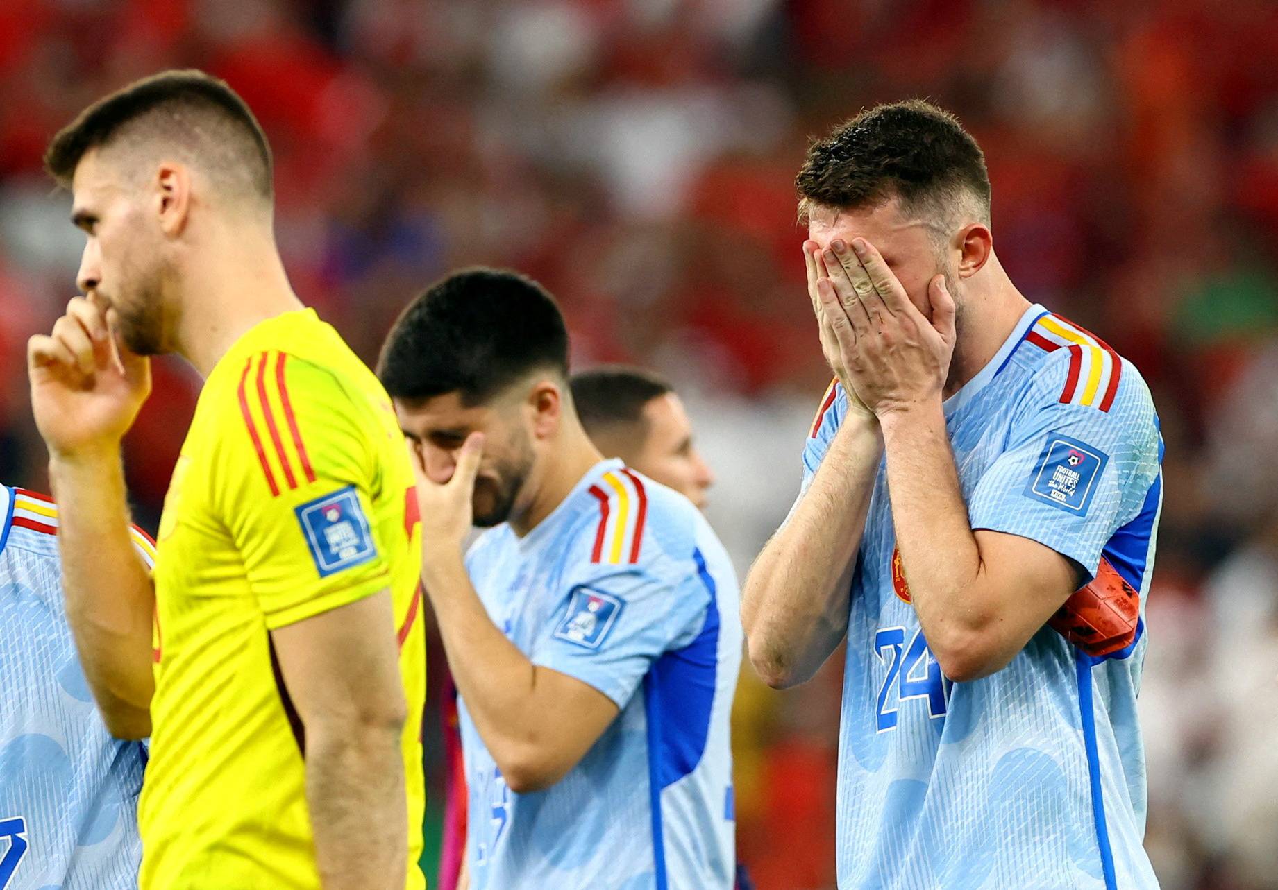 Spanish players look dejected after losing their round of 16 match against Morocco in Al Rayyan, Qatar, on Tuesday. | REUTERS