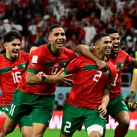 Morocco players celebrate after winning a penalty shootout with Spain at the FIFA World Cup in Al Rayyan, Qatar, on Tuesday. | AFP-JIJI