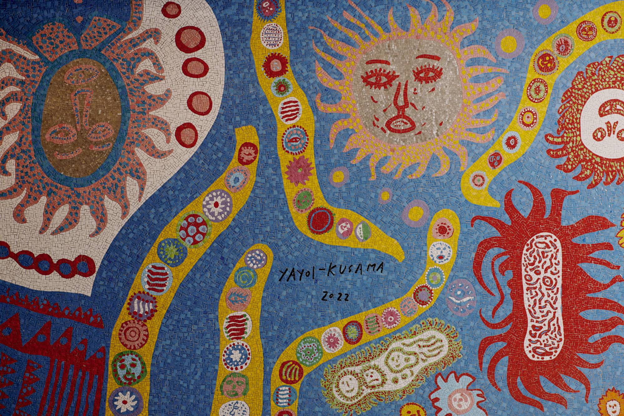 Yayoi Kusama says that the train station venue inspired her to depict many different characters coming and going. | VINCENT TULLO / THE NEW YORK TIMES