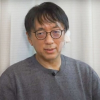 A screenshot taken from the Video News website Wednesday shows sociologist Shinji Miyadai speaking about his readiness to resume working after an assault that hospitalized him. | KYODO