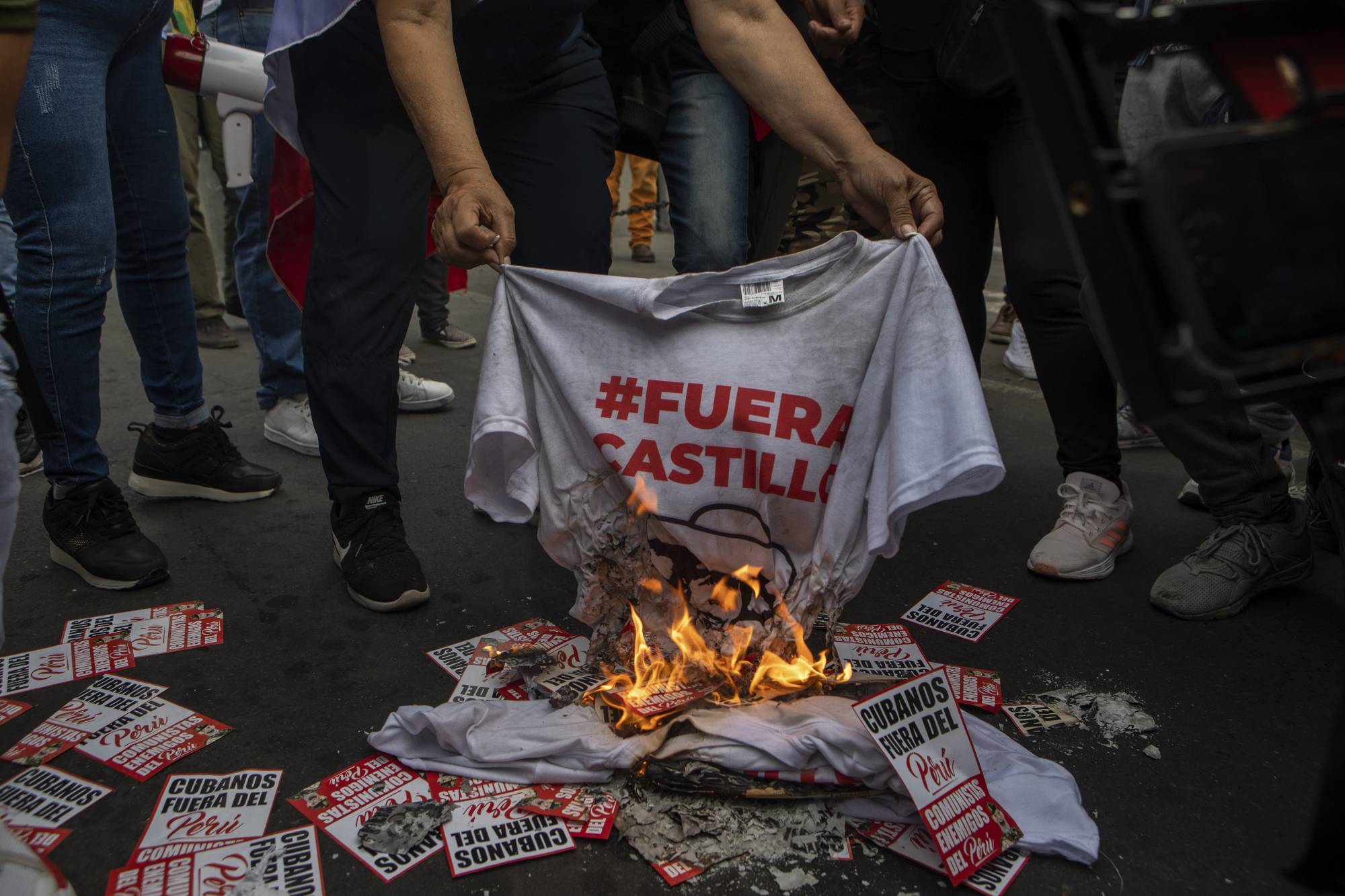 Demonstrators gather in front a police station where President Pedro Castillo was being detained in Lima on Wednesday. | Marco Garro / The New York Times