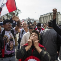Demonstrators gather in front a police station where President Pedro Castillo was taken, in Lima on Wednesday.  | MARCO GARRO / THE NEW YORK TIMES