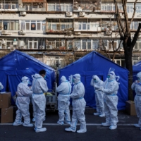 Pandemic prevention workers in Beijing on Thursday | REUTERS