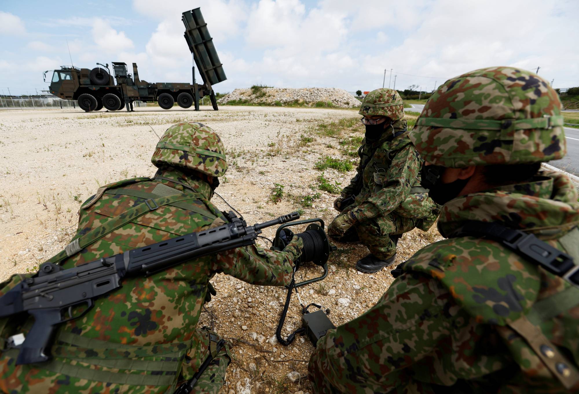 Ground Self-Defense Force members conduct a military drill next to an anti-ship missile unit at their camp on Miyako Island, Okinawa Prefecture, in April. | REUTERS