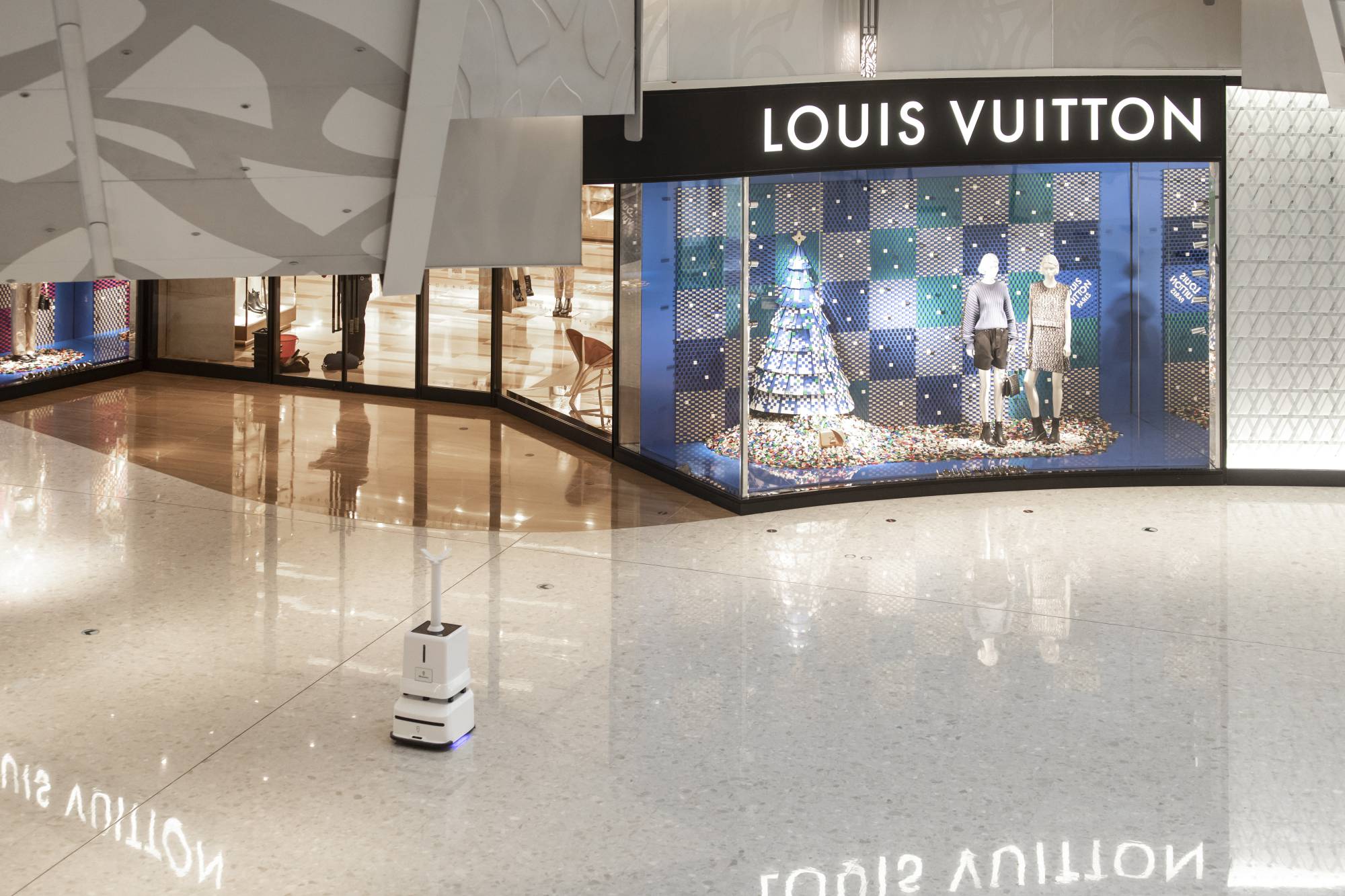An automated disinfecting robot roams through a luxury shopping mall in Shanghai on Thursday. | Qilai Shen / The New York Times