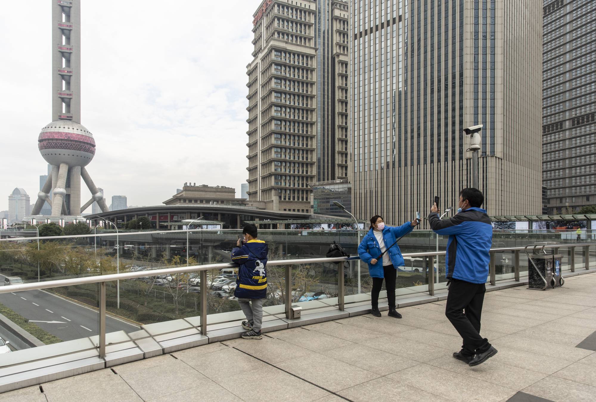 Sightseers at a walkway in the Lujiazui Financial District in Shanghai on Thursday. | Qilai Shen / The New York Times