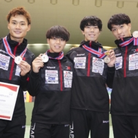 From left: Kyosuke Matsuyama, Kazuki Iimura, Takahiro Shikine and Kenta Suzumura pose with their medals after a fencing World Cup event in Tokyo on Sunday. | KYODO