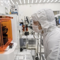 A technician checks on a stack of wafers at the Applied Materials facility in Santa Clara, California. | BLOOMBERG