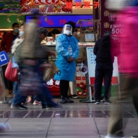 A worker in a protective suit at a food shop in Shanghai on Monday. The world’s second-biggest economy is rapidly dismantling restrictions that largely kept COVID-19 at bay for almost three years. 
 | REUTERS 