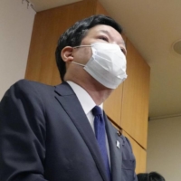 Liberal Democratic Party lawmaker Kentaro Sonoura speaks to reporters in the parliament building on Nov. 30. | KYODO