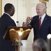 U.S. President Joe Biden toasts with President Macky Sall of Senegal during the U.S.-Africa Leaders Summit dinner in the East Room of the White House in Washington on Wednesday. | OLIVER CONTRERAS / THE NEW YORK TIMES