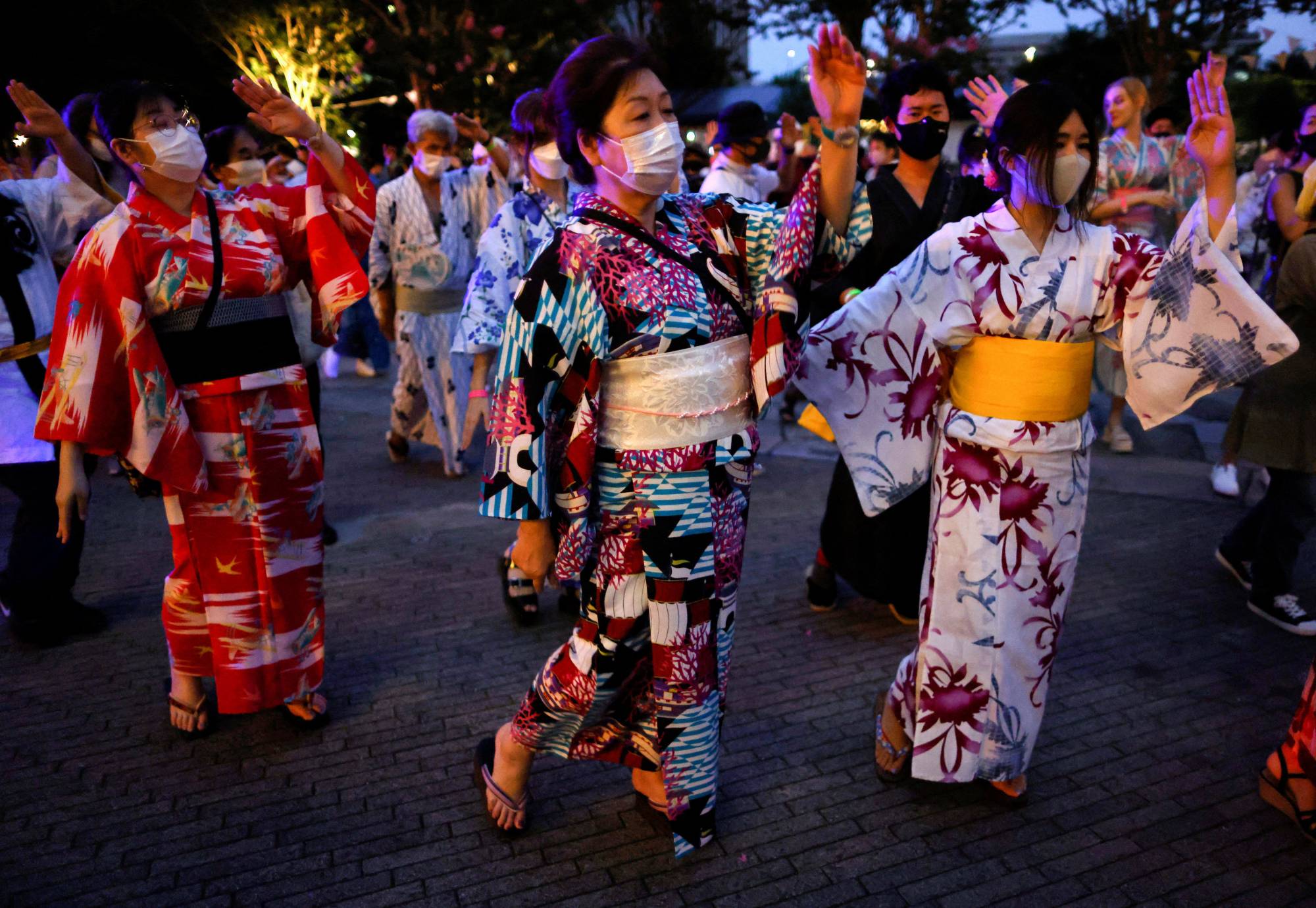 Revelers take part in a Bon Odori festival in Tokyo's Nakano Ward on Aug. 6. Even as Japan eased COVID-19 measures and avoided the states of emergency of years past, many still took a cautious approach to daily life and public events. | Reuters
