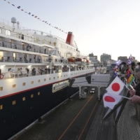People see off the cruise ship Nippon Maru as it departs from Yokohama port on Thursday. | KYODO