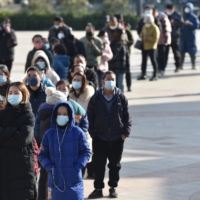 People line up to buy antigen test kits at a pharmacy in Nanjing, in China\'s eastern Jiangsu province, on Thursday. | AFP-JIJI