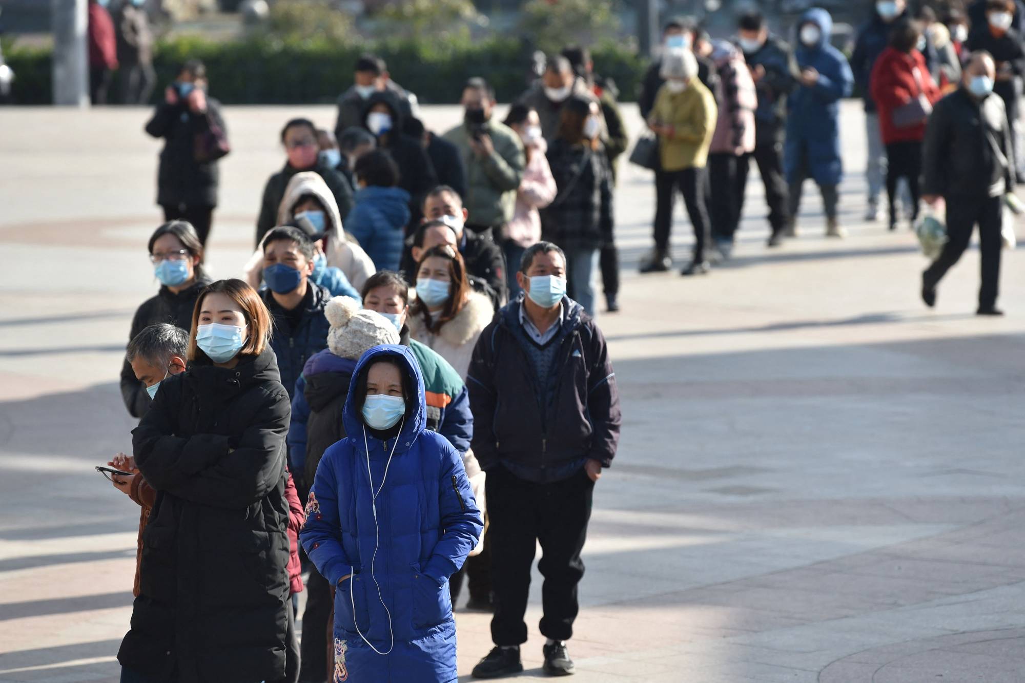 People line up to buy antigen test kits at a pharmacy in Nanjing, in China's eastern Jiangsu province, on Thursday. | AFP-Jiji