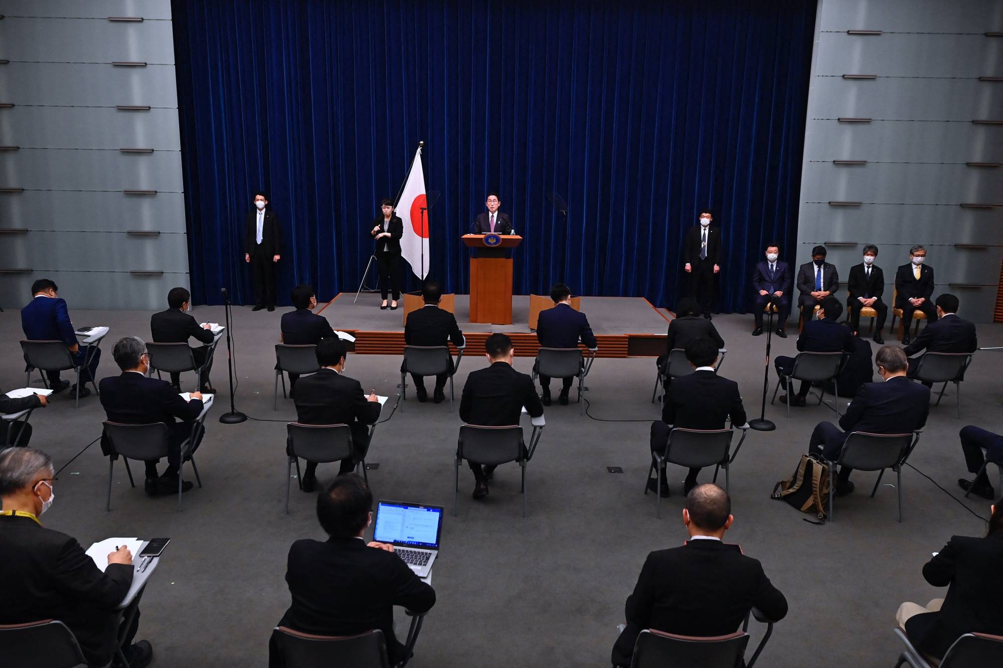 Prime Minister Fumio Kishida speaks on a news conference in Tokyo on Friday after the Japanese government approved a major defense policy overhaul. | AFP-JIJI