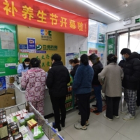 Residents line up at a pharmacy to buy antigen testing kits for COVID-19 in Nanjing on Thursday. | REUTERS